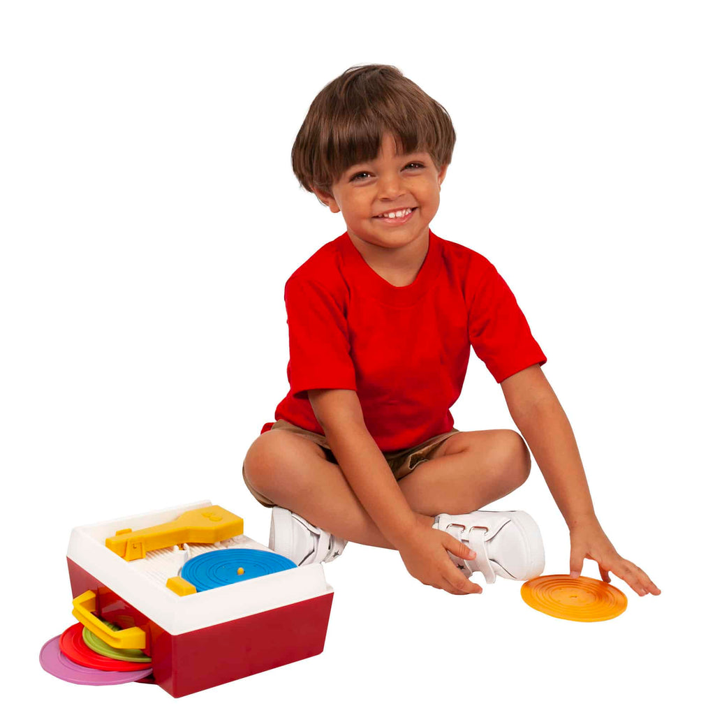 Lifestyle shot of boy playing with the Fisher-Price Music Box Record Player