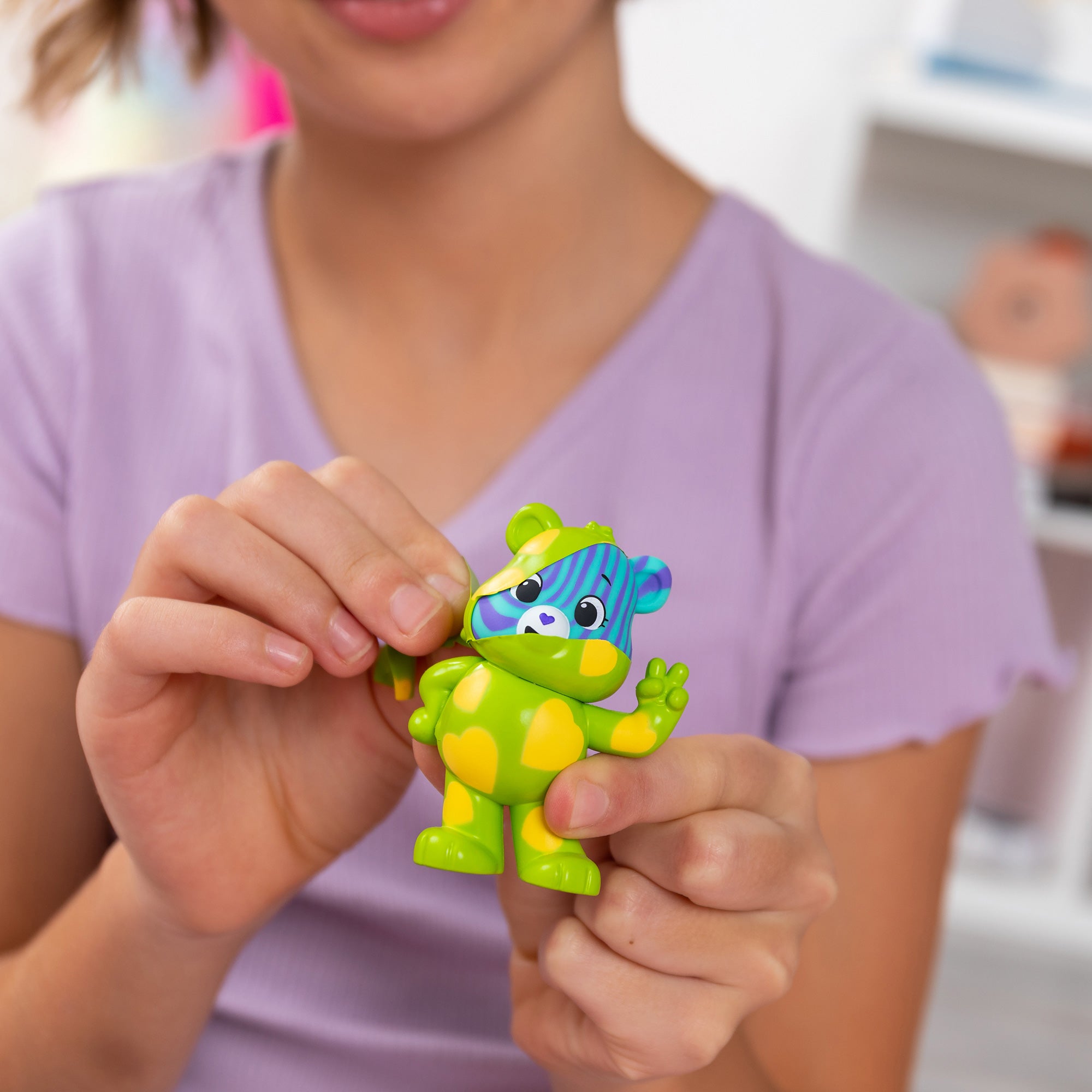 Care Bears Peel and Reveal - Lifestyle shot of girl peeling bear