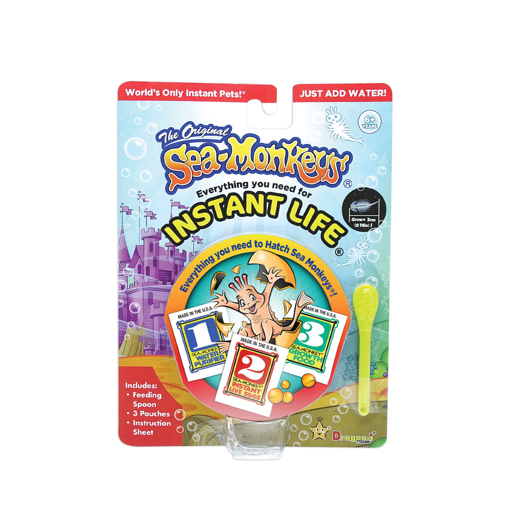 The front of a package with the product name and information visible, along with a modern illustration of a Sea-Monkey bursting out of an egg.